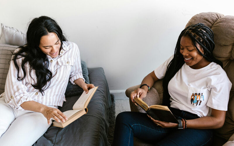 Two Young Women Reading Books